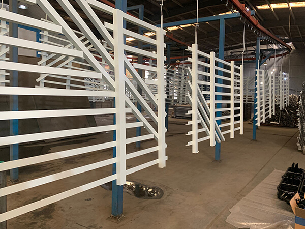 Aluminum fence after powder coating is hanging in the factory.