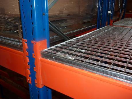 A part of carbon steel shelf rack supported by vertical blue brackets and horizontal orange brackets.
