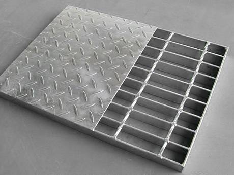 A compound steel grating with half of checkered steel plate on it.