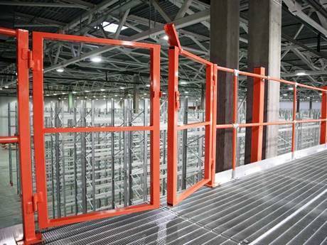 Dense steel grating used as platform in the warehouse of factory.