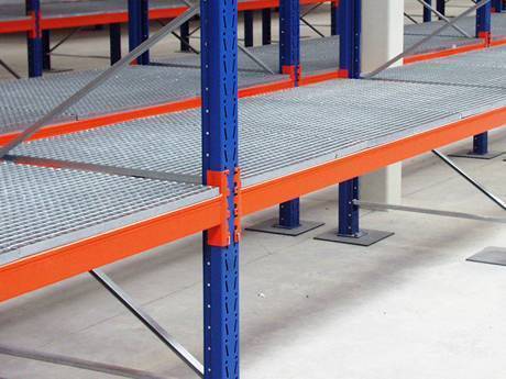 A part of galvanized steel shelf rack supported by vertical blue brackets and horizontal orange brackets.