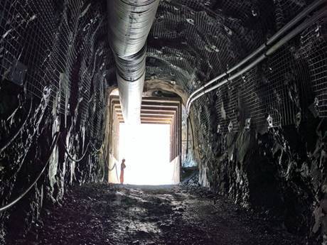 A worker is walking to check the mine road.