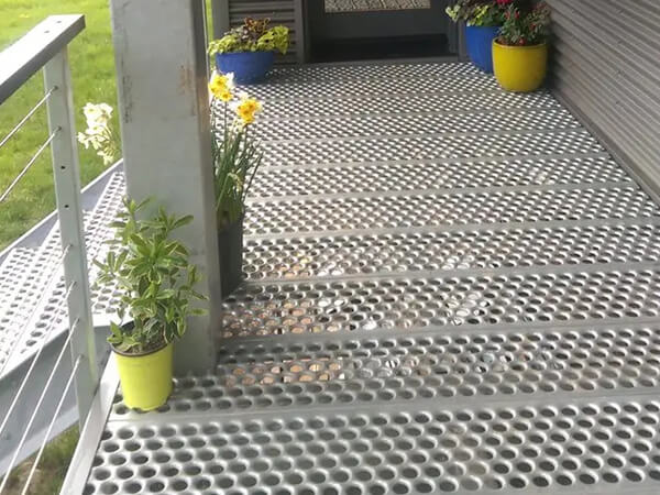 The perforated steel grating is installed as the walkway and stairs.