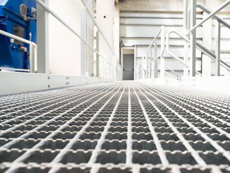 Serrated welded steel grating used as floor for people to walk.