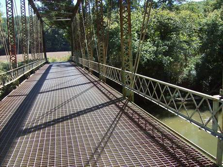 Steel grating bridge crossing the river.