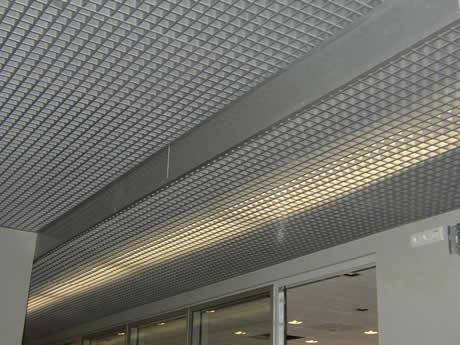 The picture shows a part of the steel grating ceiling in an office.