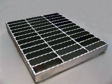 A piece of steel grating infill panel with serrated surface and end plates.