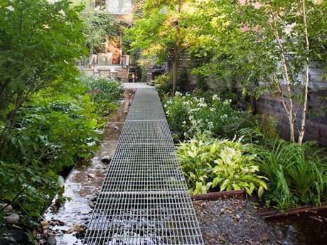 This is a walkway surrounded by many trees in the park.